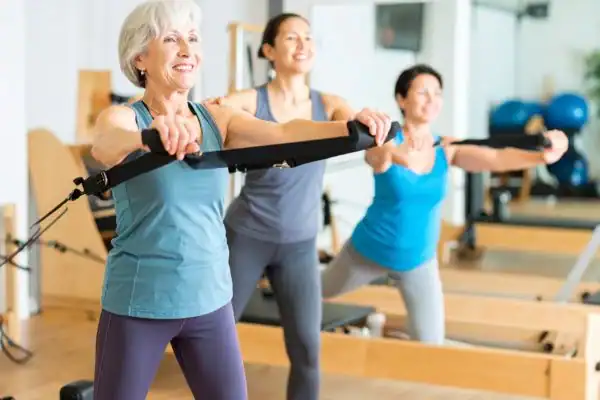 older woman doing weight training Ramsgate and resistance in the gym to tone upper arms