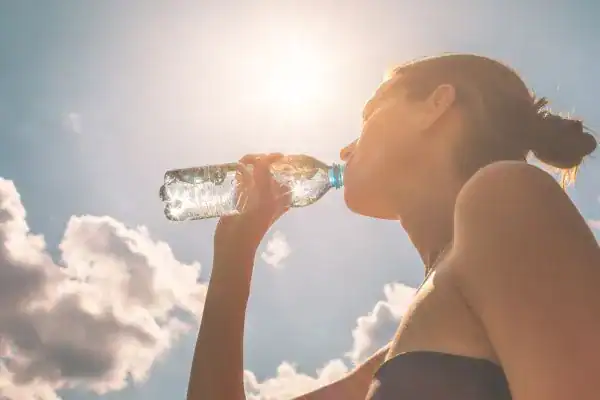 Image of woman drinking water to hydrate Ramsgate after run.